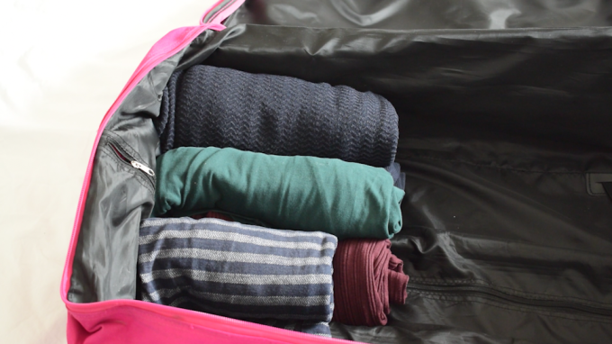 Clothes rolled in suitcase
