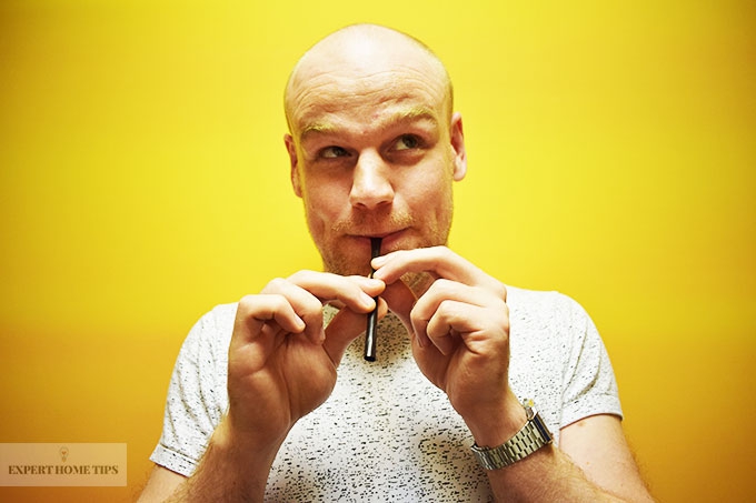 Man plays flute made out of a straw