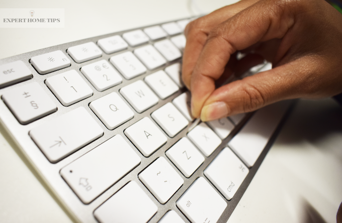 Use sellotape to clean inbetween keyboard keys