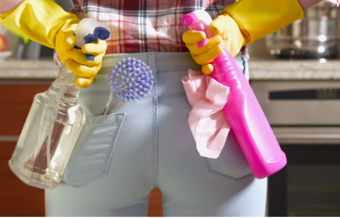 Woman holding cleaning products 