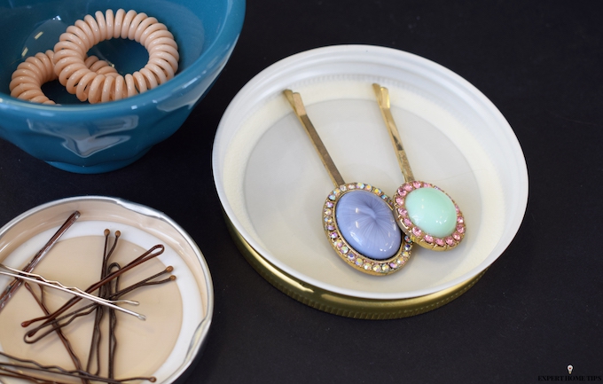 organising hair accessories in empty jar lids