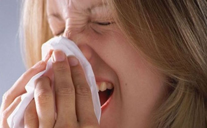 Woman sneezing