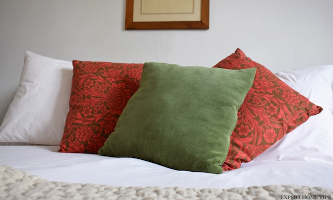 Bed with floral throw cushions