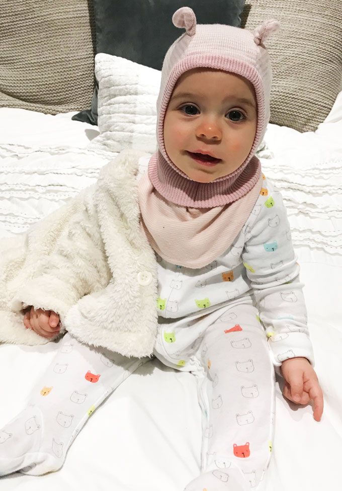 baby laughing on bed