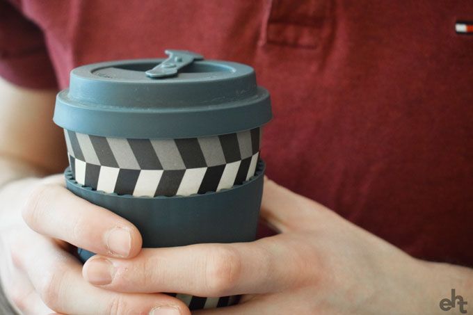 person holding keep cup flask