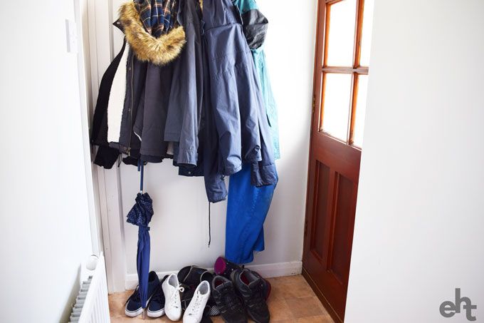 messy entryway with too many coats